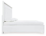 Ashley Furniture Chalanna upholstered storage bed with a padded headboard and built-in storage drawers in a modern bedroom setting.
