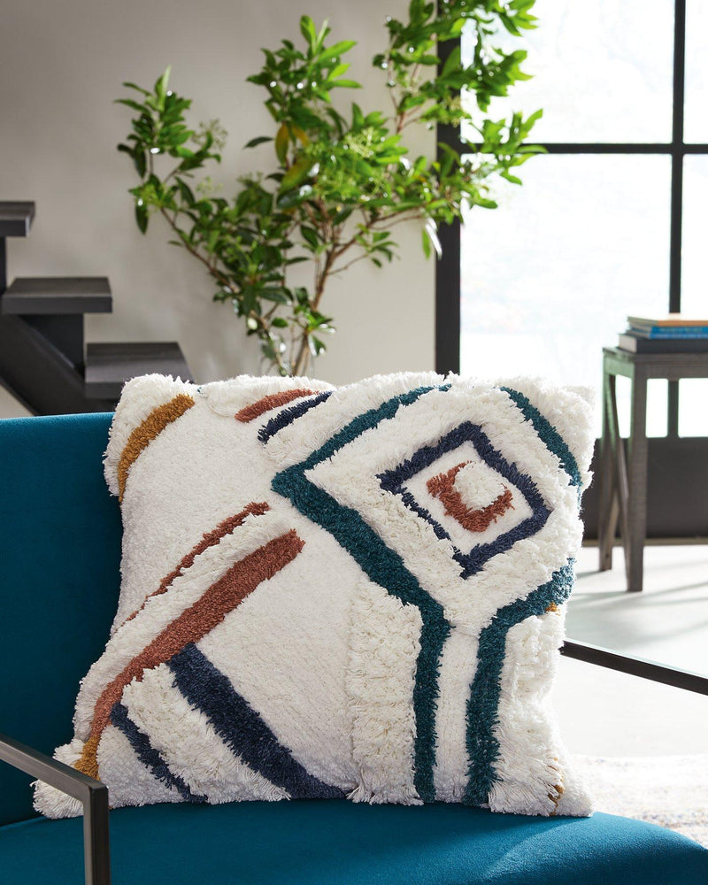 Set of four Ashley Furniture Evermore pillows with plush fabric in neutral tones, perfect for bedroom or living room decor.