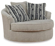 Ashley Furniture Calnita living room set featuring a sofa and armchair with neutral upholstery and modern design.