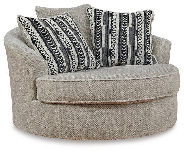 Ashley Furniture Calnita living room set featuring a sofa and armchair with neutral upholstery and modern design.
