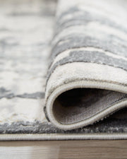 Ashley Furniture Mazatl 7'10" x 10'2" rug with intricate pattern and soft texture, suitable for living rooms or bedrooms.