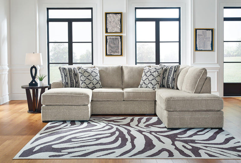 Ashley Furniture Calnita living room set with a sofa and armchair, featuring neutral upholstery and modern design accents.