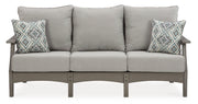 Ashley Furniture Visola outdoor sofa and loveseat set with coffee table, featuring cushioned seating and stylish outdoor design.