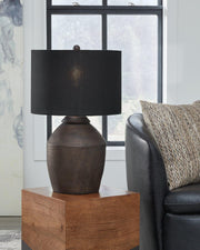 Naareman Ashley Furniture table lamp with a sleek base and fabric shade, placed on a modern wooden side table.