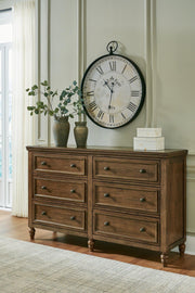 Ashley Furniture Sturlayne dresser with matching mirror, showcasing a modern wooden dresser and rectangular mirror in a stylish bedroom setting.