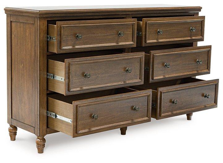 Ashley Furniture Sturlayne dresser with matching mirror, featuring a modern wooden design with multiple drawers and a sleek frame.