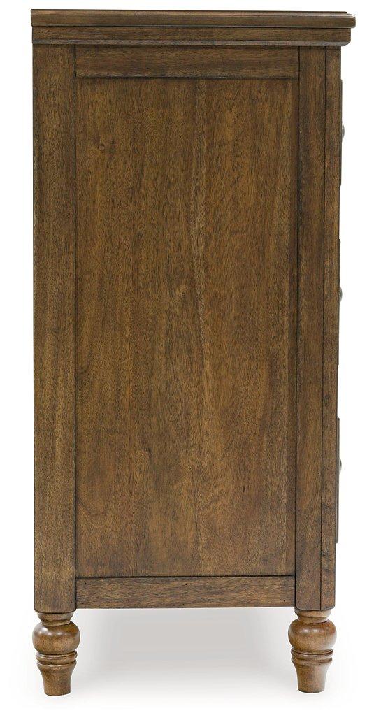 Ashley Furniture Sturlayne dresser and mirror set showing a wooden dresser with a matching mirror in a modern bedroom setting.