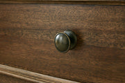 Ashley Furniture Sturlayne dresser with matching mirror, featuring a dark wood finish and modern design for bedroom storage.