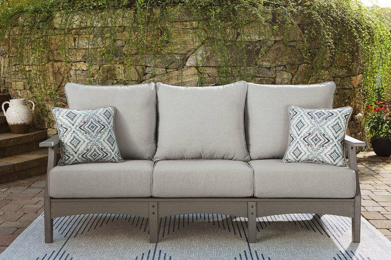 Ashley Furniture Visola outdoor seating set featuring a sofa, loveseat, and coffee table with weather-resistant cushions and modern design.