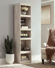 Willowton Pier media tower by Ashley Furniture with multiple shelves and storage compartments, dark wood finish, modern design.