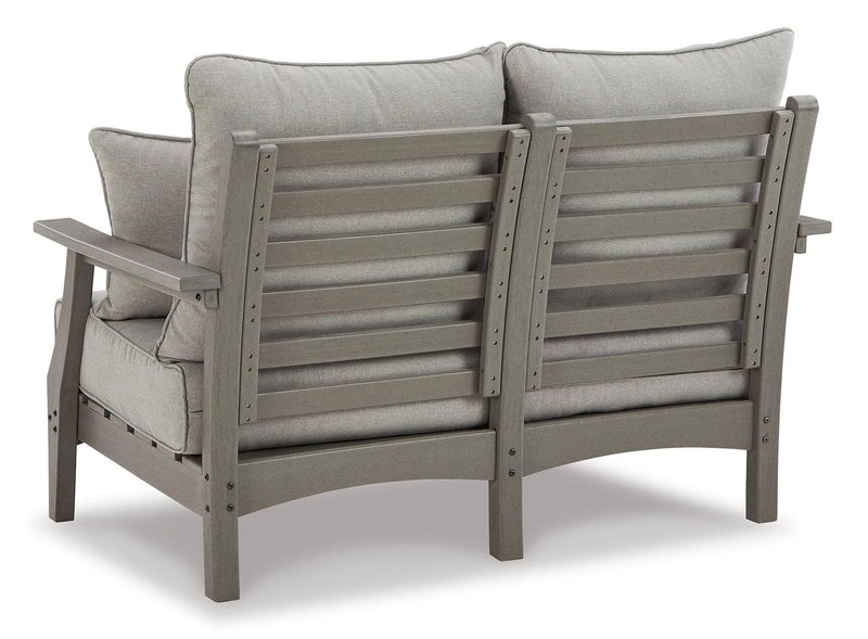 Outdoor seating set with Ashley Furniture loveseat and coffee table, featuring woven rattan design for patio relaxation.