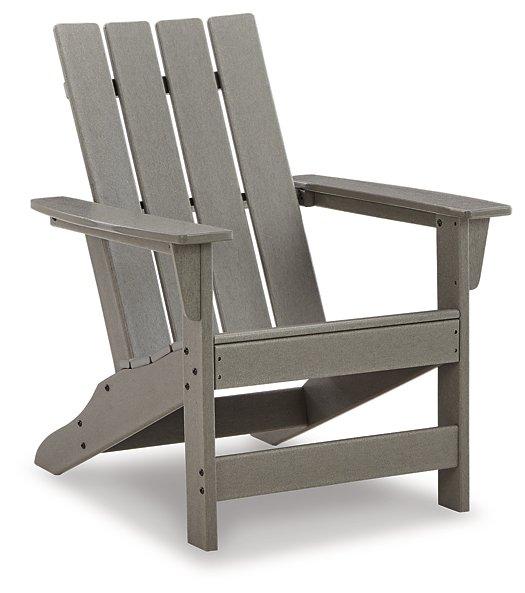 Outdoor Ashley Furniture Visola Adirondack Chair with matching end table in a garden setting, perfect for outdoor relaxing.