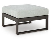 Outdoor Ashley Furniture Beachloft outdoor seating set with cushioned chairs and table on patio, perfect for relaxing outdoors.