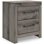 Graystorm bedroom set by Ashley Furniture, featuring a bed, nightstands, and matching dresser in a modern bedroom scene.