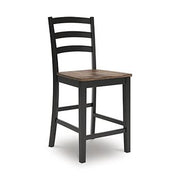 Wildenauer counter height barstool by Ashley Furniture with wooden legs and a cushioned seat, ideal for kitchen or bar area.