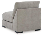 Ashley Furniture Aslan Court sectional sofa with plush cushions and modern design, shown in a cozy living room setting.
