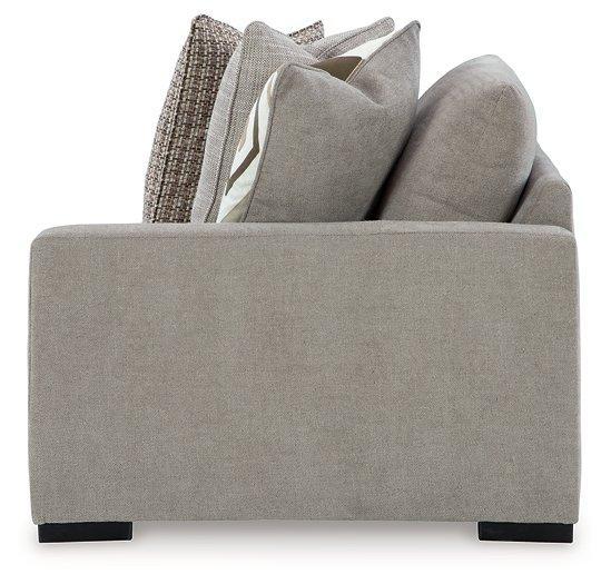 Ashley Furniture Aslan Court Sectional sofa with plush cushions and neutral fabric in a modern living room setting.