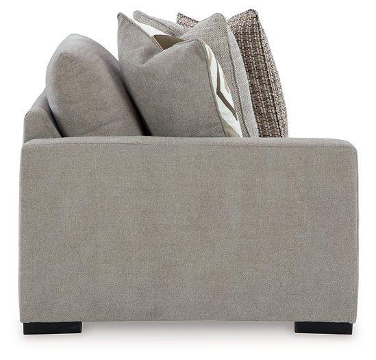 Ashley Furniture Aslan Court Sectional sofa with plush cushions and modern design, shown in a cozy living room setting.