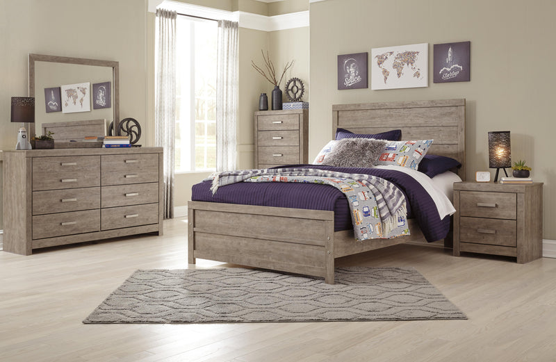 Ashley Furniture Culverbach Bed with a classic wooden frame and detailed headboard, shown in a cozy bedroom setting.