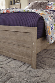 Ashley Furniture Culverbach Bed with detailed wooden headboard and frame, showcasing elegant craftsmanship and rich finish.