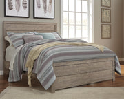 Ashley Furniture Culverbach Bed with upholstered headboard and wooden frame, shown in a close-up view.