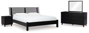 Ashley Furniture Danziar bedroom set with a modern bed frame, matching nightstands, and coordinating dresser in a stylish bedroom.
