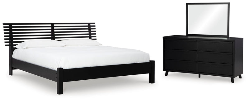 Ashley Furniture Danziar bedroom set includes a bed frame, nightstands, and dresser with modern design and neutral finish.