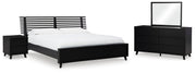 Ashley Furniture Danziar bedroom set with a modern bed frame, nightstands, and matching dresser in a stylish bedroom setting.