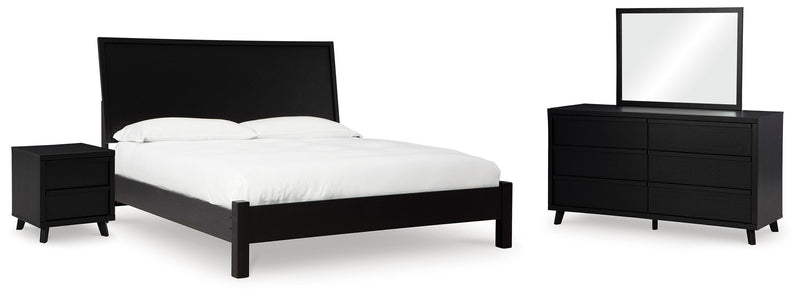 Ashley Furniture Danziar bedroom set with a modern bed frame, matching nightstands, and elegant design in a stylish bedroom scene.