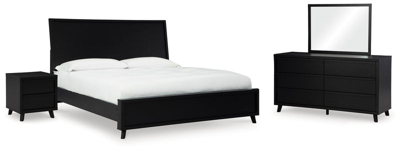 Ashley Furniture Danziar bedroom set with a modern bed frame, matching nightstands, and dresser in a stylish bedroom arrangement.