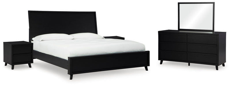 Ashley Furniture Danziar bedroom set with a modern bed frame and matching nightstands in a cozy bedroom setting.