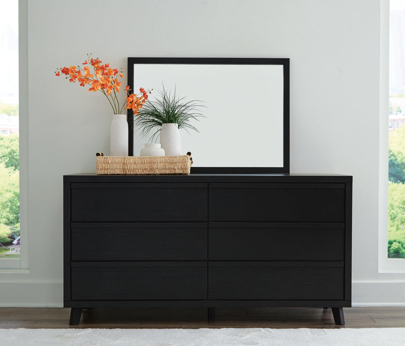 Ashley Furniture Danziar bedroom set with modern bed frame, matching nightstands, and dresser in a stylish bedroom layout.