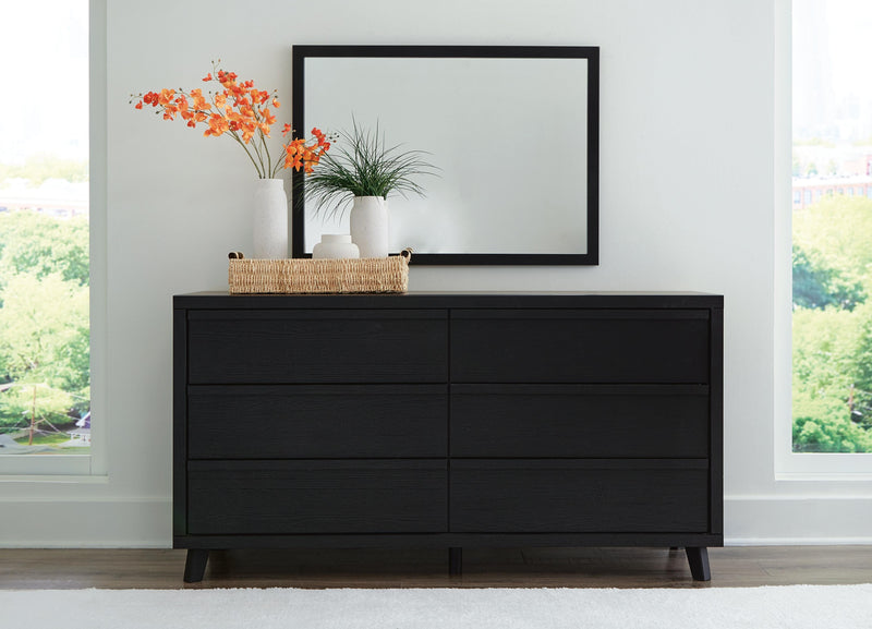 Ashley Furniture Danziar dresser with matching mirror, featuring a modern wood finish and sleek design for bedroom storage.
