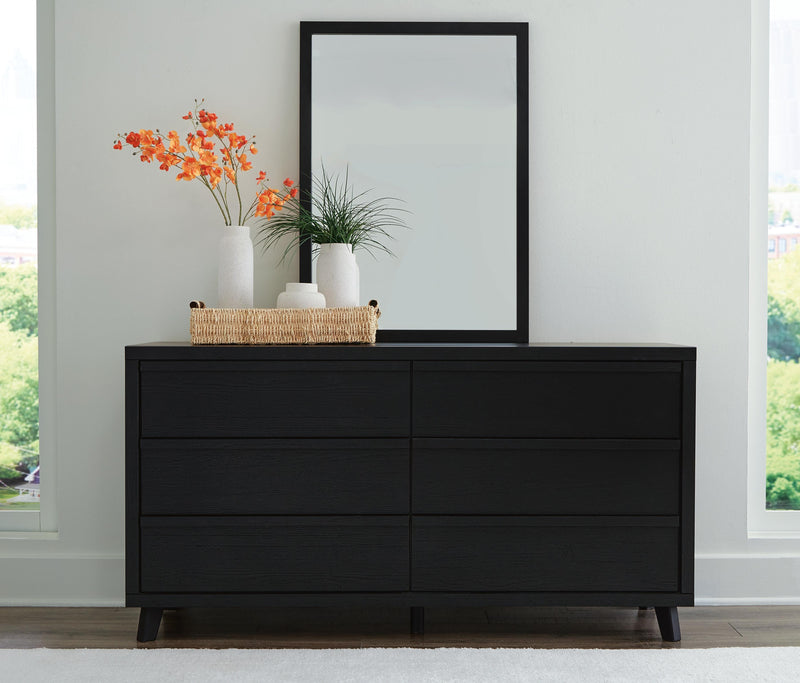 Ashley Furniture Danziar dresser with matching mirror, wooden storage unit with multiple drawers and a sleek mirror attached.