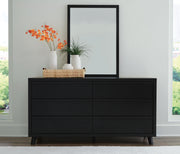 Ashley Furniture Danziar bedroom set with a modern bed frame, matching nightstands, and a coordinated dresser in a stylish bedroom setting.