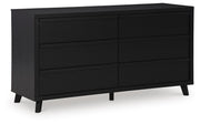 Ashley Furniture Danziar dresser with multiple drawers, hardwood finish, and sleek modern design, viewed from a side angle.