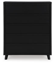 Ashley Furniture Danziar wide chest of drawers with sleek wood finish and multiple drawers, shown from a front head-on view.