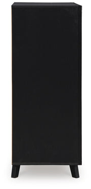 Side view of Ashley Furniture Danziar wide chest of drawers showing multiple drawers and wood finish.