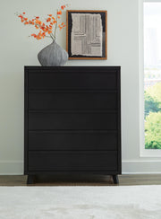 Ashley Furniture Danziar wide chest of drawers with six spacious drawers and a sleek wood finish.