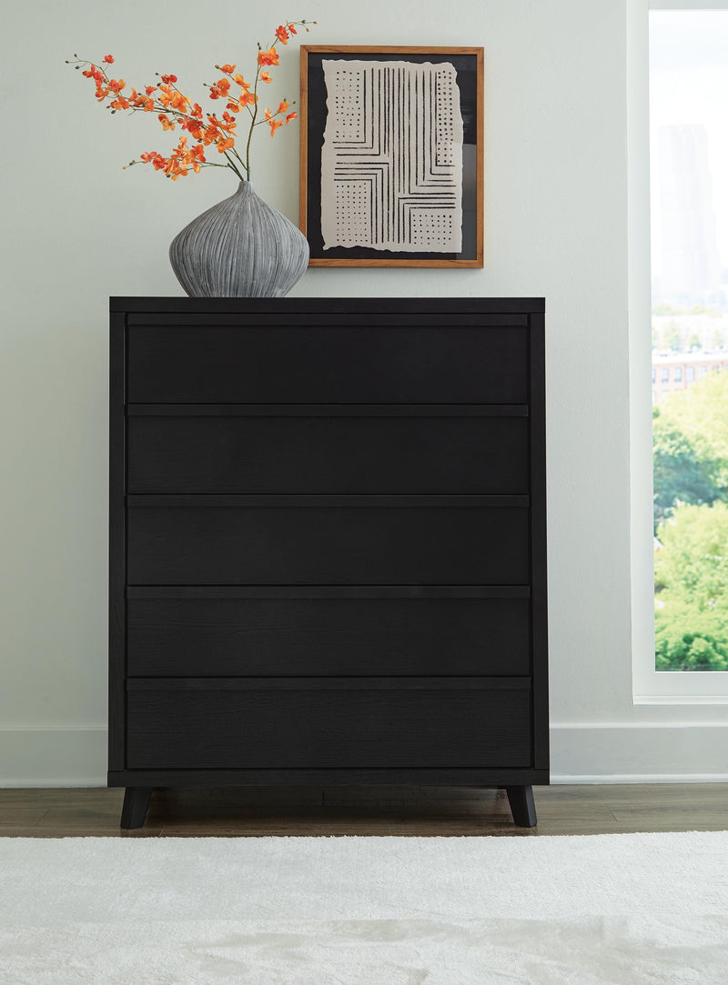 Ashley Furniture Danziar wide chest of drawers with six spacious drawers and a sleek wood finish.