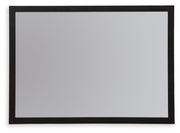 Ashley Furniture Danziar bedroom mirror with a sleek rectangular frame, mounted on a wall, showcasing modern bedroom decor.