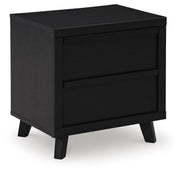 Ashley Furniture Danziar nightstand with dark wood finish and open shelf, shown from an angled view.