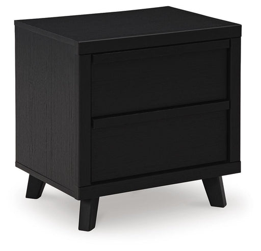Ashley Furniture Danziar nightstand with dark wood finish and open shelf, shown from an angled view.