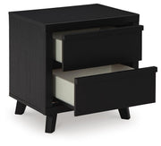 Ashley Furniture Danziar bedroom set with a modern bed frame, nightstands, and dresser in a stylish bedroom scene.