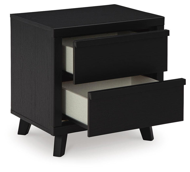 Ashley Furniture Danziar bedroom set with a modern bed frame, nightstands, and dresser in a stylish bedroom scene.