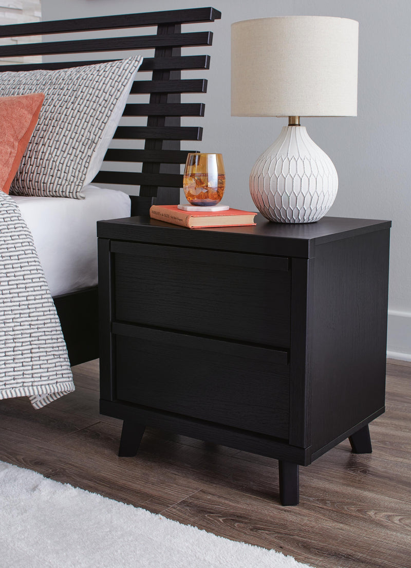 Ashley Furniture Danziar bedroom set with a modern bed frame, matching nightstands, and dresser in a stylish bedroom scene.