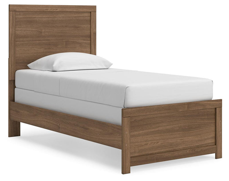 Ashley Furniture Broachmyn Bed with a stylish headboard and wooden frame, shown from an angled view in a well-lit bedroom setting.