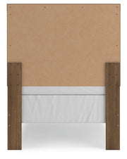Ashley Furniture Broachmyn Bed with a sleek wooden frame and headboard, shown in a modern bedroom setting.