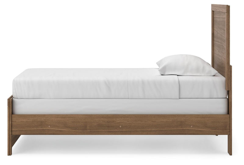 Ashley Furniture Broachmyn Bed with a stylish upholstered headboard and wooden frame, shown from a side angle.
