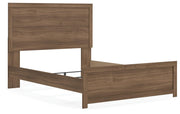 Ashley Furniture Broachmyn Bed with a stylish wooden frame, shown from an angled view in a modern bedroom setting.